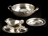 three pieces of silverware including a saucer, saucer and plate