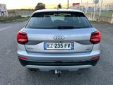 the rear end of a silver audi car parked in a parking lot