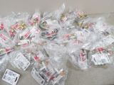 many bags of candy sitting on a couch next to a remote control