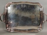 silver plated serving tray with handles and handles on a table