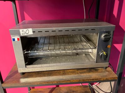a toaster oven sitting on a shelf in a room