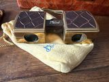 a pair of binoculars sitting on top of a bag