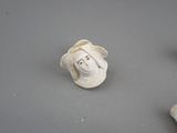 three figurines of a woman and a man on a table