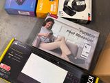 a box with a remote, a remote control, and a box with headphones on it