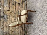a chair that is sitting on the side of a stone wall