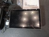 a tablet that is sitting on a table next to other electronics
