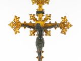 an image of a golden cross with a statue of jesus on it