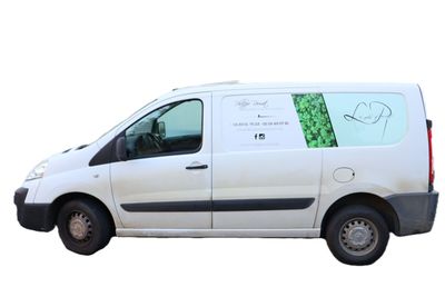 a white van with a green sticker on the side of it