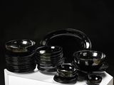 a white box with black plates and bowls on it