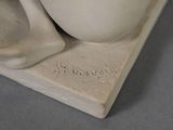 a statue of a cup and spoon on a table