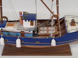 a model of a boat on display on a white surface