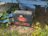 a small box sitting on the ground next to a boat