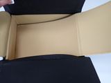 a person opening a black box with a black handle