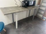 a small table with a coffee maker on top of it
