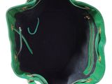 the inside of a green purse with gold zippers on a white background