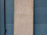 a door that is standing in front of a blue wall