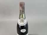 a bottle of wine that is sitting on a table