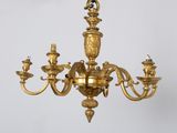 a gold colored chandelier hanging from the ceiling