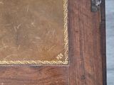a wooden table with a brown leather cover on top of it