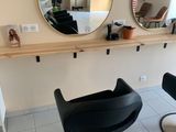 deux chaises noires dans une pièce aux murs recouverts de miroirs