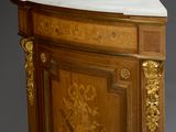 a cabinet with a marble top and gold decorations on it
