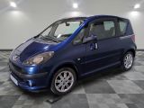 a picture of a small blue car on a checkered floor