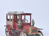 a red toy car with a man sitting in it