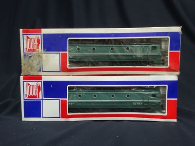 pair of green and red train cars sitting on top of each other