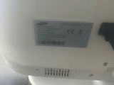 a close up of a white toilet with a button on it