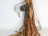 a broom with a handle and some brown strips on it