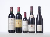 several bottles of wine are lined up on a table