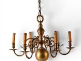 brass chandelier with five arms and five lights hanging from the ceiling