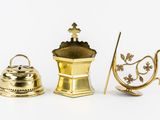 three different types of brass objects on a white surface