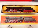 two toy trains that are sitting on a table
