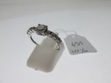 a close up of a ring on a white surface with a price tag