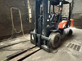 un chariot élévateur à fourche garé dans un entrepôt