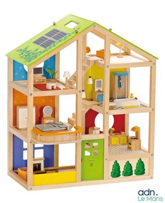 wooden doll house with solar panels on the roof and windows