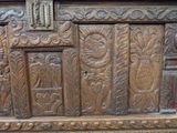 a wooden bench with carvings on it in a room