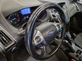 a steering wheel and dashboard of a car in a car showroom