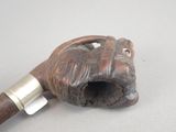 a pipe with a wooden handle on a table