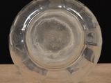 a clear glass object sitting on a wooden table