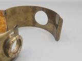a close up of a metal bracelet with a ring on it