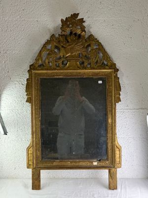 a mirror that is sitting on a shelf in a room
