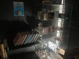 a glass case with books on it in a dark room