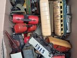 a cardboard box filled with assorted toys and other items