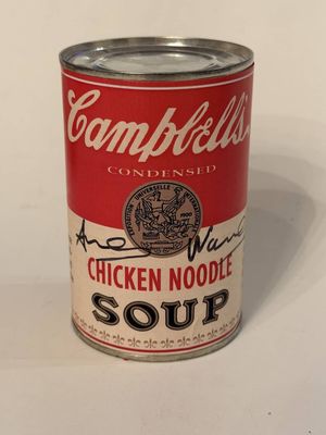 campbell ' s chicken noodle soup in a can on a white surface