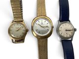 three different types of watches are displayed on a white surface