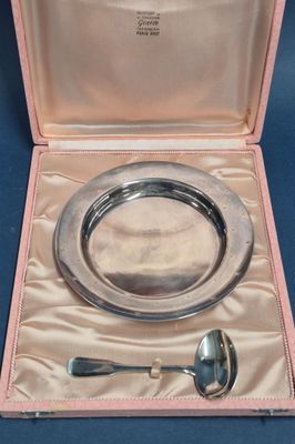 a silver plate with a spoon and a spoon in it