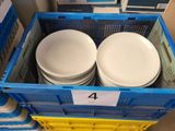 four white plates in a blue crate with a price tag