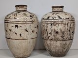 two vases sitting next to each other on a table
